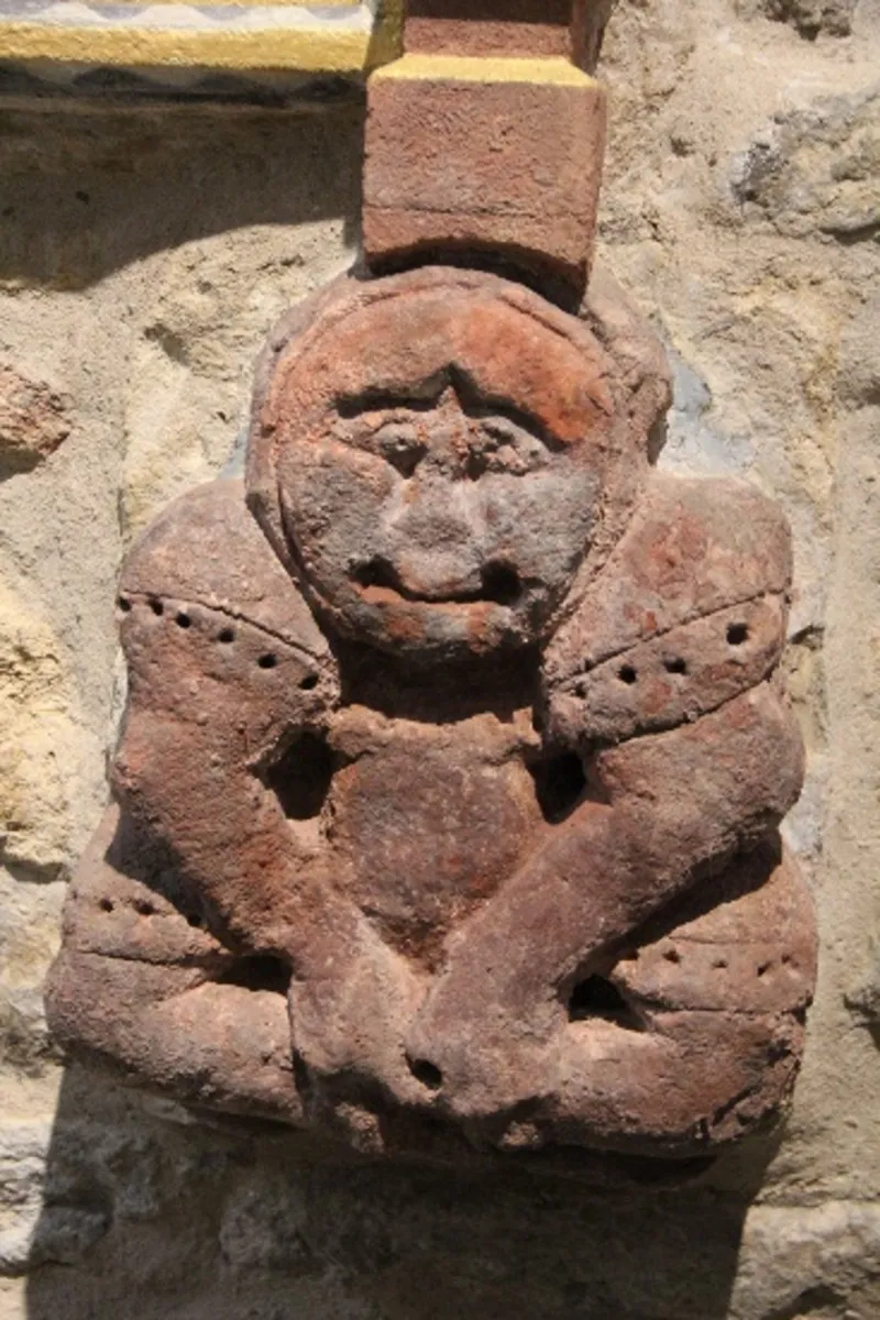 An ancient carving, possibly a jester.